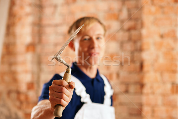 Stock photo: bricklayer with trowel on construction site