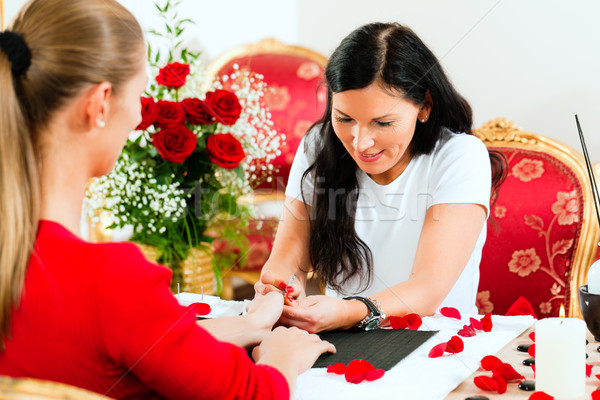 Woman in nail salon receiving manicure Stock photo © Kzenon