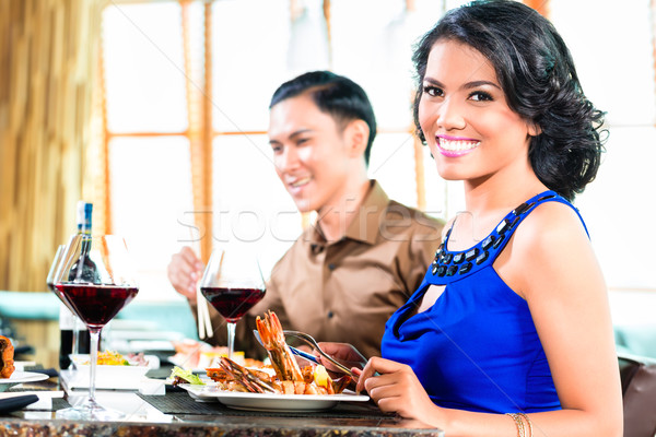 Asian Friends eating  in restaurant Stock photo © Kzenon