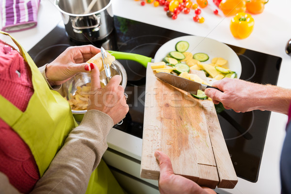 Young couple cooking together in kitchen Stock photo © Kzenon