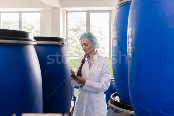 Manufacturing employee writing report during quality control in  Stock photo © Kzenon