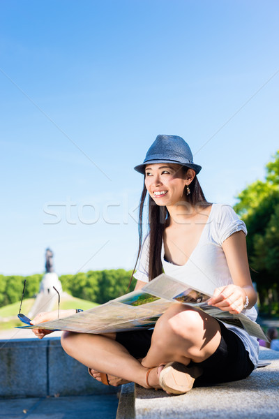 Asian female tourist holding a map outdoors Stock photo © Kzenon