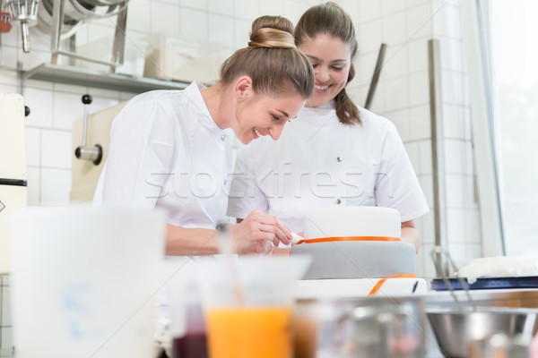 Women in fine backer or pastry shop baking cakes Stock photo © Kzenon