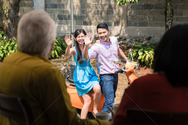 Man and woman waving goodbye to their parents after visiting them Stock photo © Kzenon