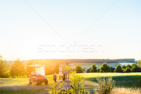 Full length of woman and her partner or instructor holding various golf clubs Stock photo © Kzenon