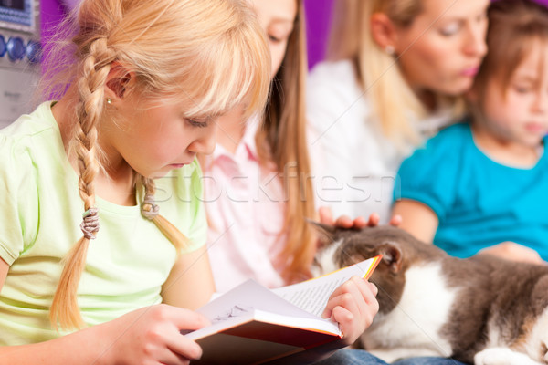 Stock photo: Mother is reading a book