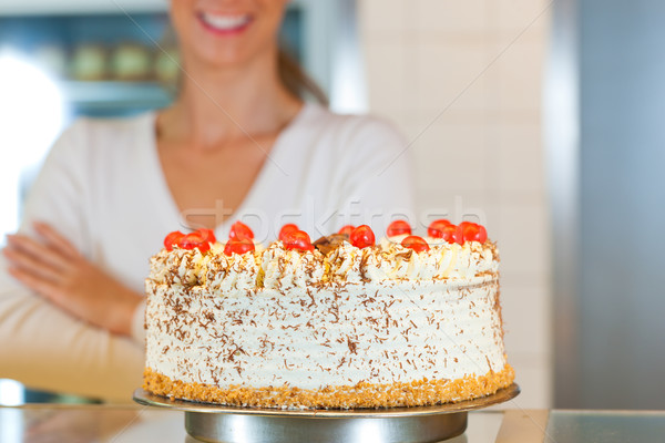 Stock photo: Female baker or pastry chef with torte