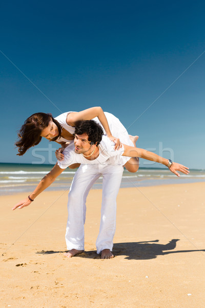 Couple enjoying freedom on the beach Stock photo © Kzenon