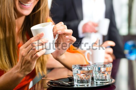 Young woman holding cup of coffee in hand Stock photo © Kzenon