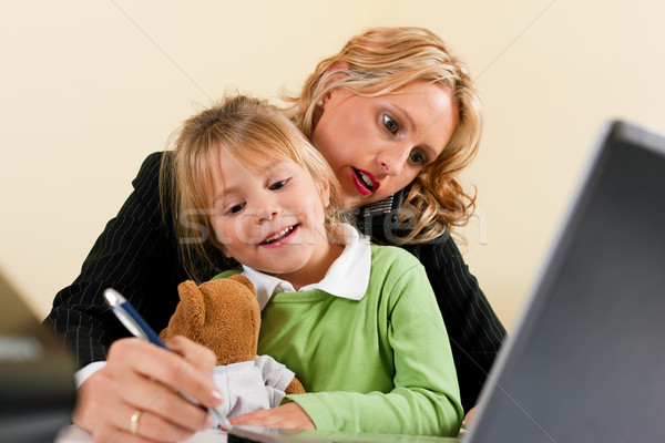 Businesswoman and mother is working at home Stock photo © Kzenon