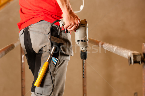Zdjęcia stock: Pracownik · budowlany · strony · wiercenia · stałego · człowiek · budowy