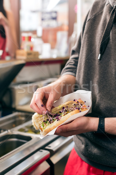 Stock photo: salesman making hotdog in fast food snack bar