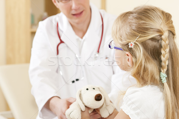 Child giving a soft toy to doctor Stock photo © Kzenon