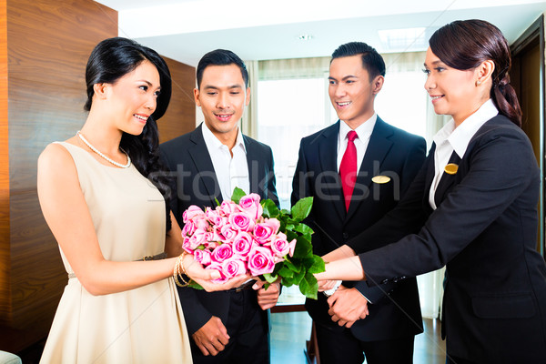 Staff greeting guests in Asian hotel Stock photo © Kzenon