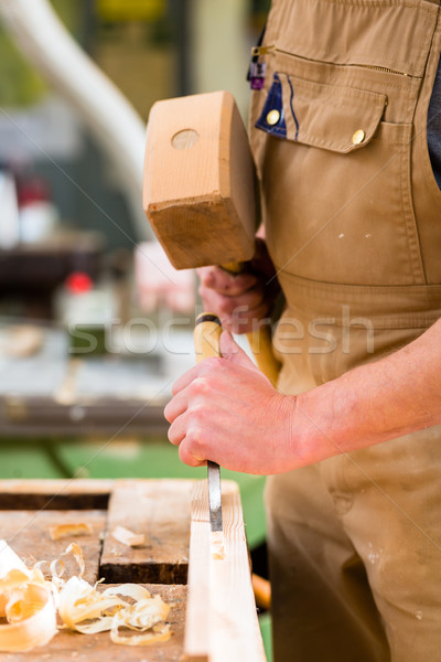 Carpenter with chisel and hammer Stock photo © Kzenon