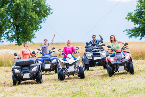 Stock photo: Friends driving off-road with quad bike or ATV