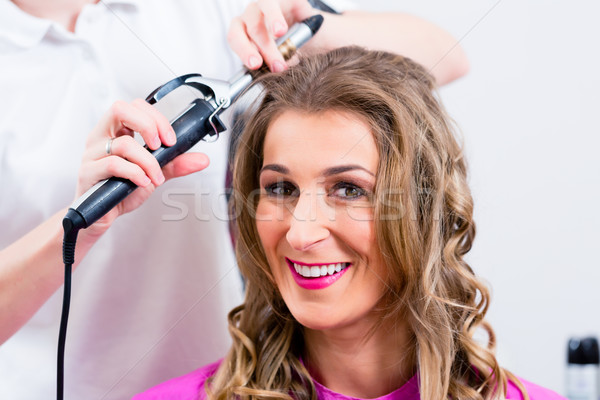Customer at hairdresser with hair spray in salon Stock photo © Kzenon