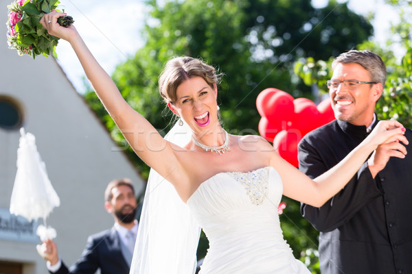 Stock photo: Bride running away with priest after wedding