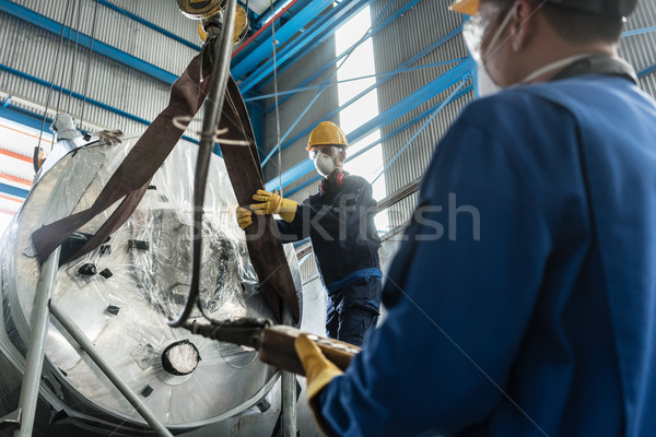 Workers handling equipment for lifting industrial boilers Stock photo © Kzenon