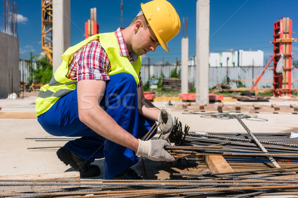 Reliable worker checking the quality of the steel bars Stock photo © Kzenon