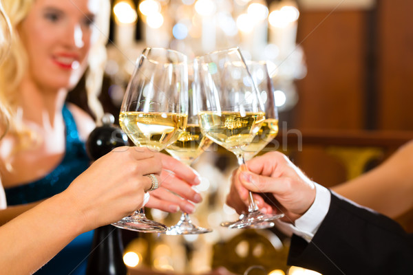 Man and woman tasting Champagne in restaurant Stock photo © Kzenon