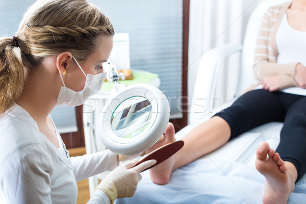 Woman in poidatry studio receiving pedicure Stock photo © Kzenon