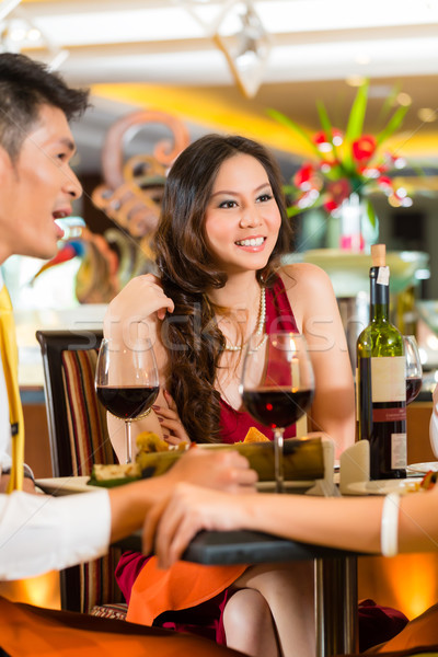 Chinese business people dining in elegant restaurant Stock photo © Kzenon