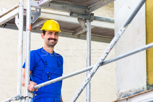 Builder on construction site at scaffold Stock photo © Kzenon