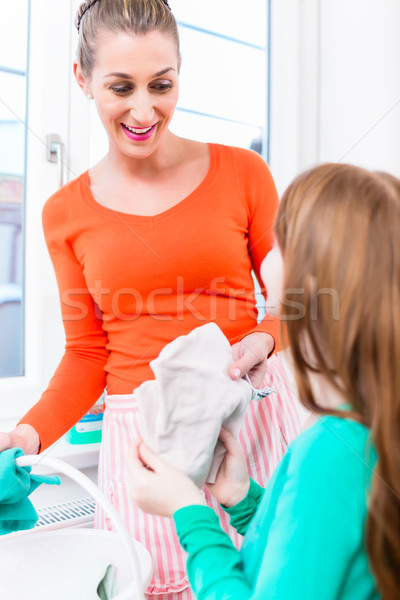 Mother and daughter cleaning window in apartment Stock photo © Kzenon