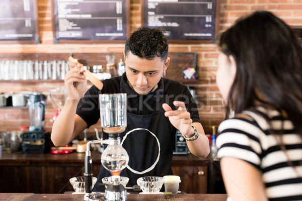 Woman watching barista preparing drip coffee in cafe Stock photo © Kzenon