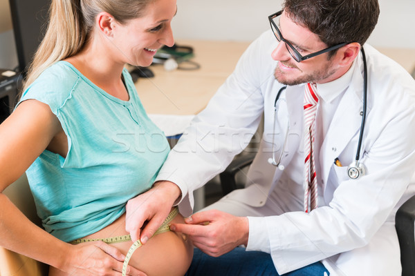 Gynecologist measuring belly of pregnant woman Stock photo © Kzenon