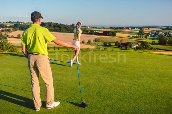 Man watching his partner striking the ball during match on the g Stock photo © Kzenon