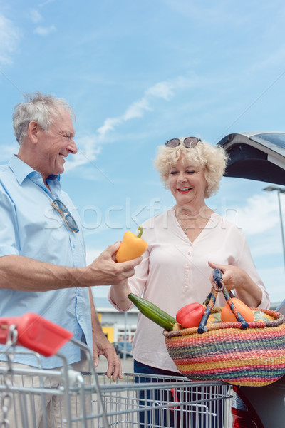 Cheerful senior couple happy for buying fresh vegetables from th Stock photo © Kzenon