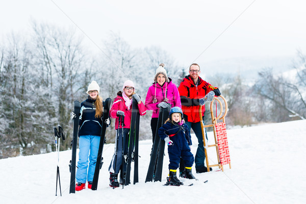 Family in winter vacation doing sport outdoors Stock photo © Kzenon