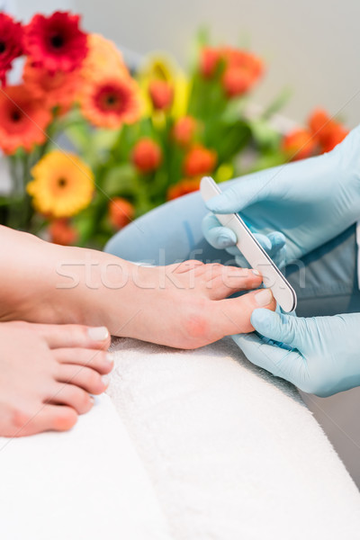 Close-up of the hands of a nail technician wearing surgical gloves Stock photo © Kzenon