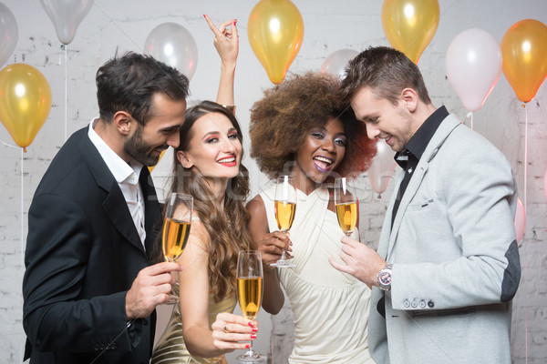 Group of party people celebrating with drinks Stock photo © Kzenon