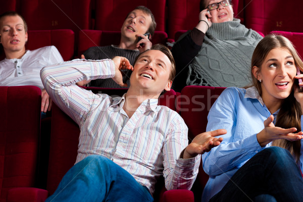 Stock photo: people in cinema theater with mobile phone