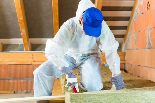 Worker cutting insulating material Stock photo © Kzenon