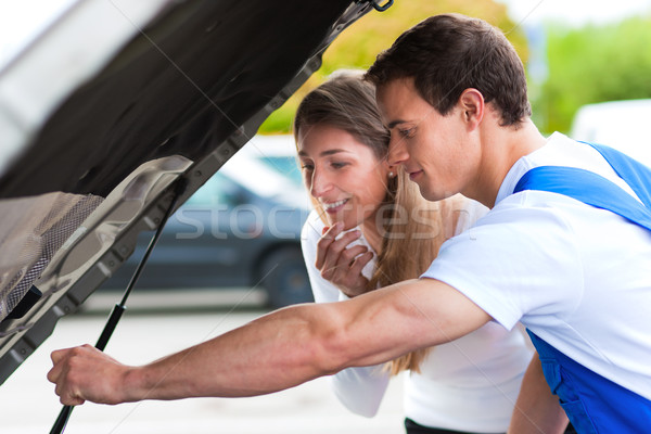 Woman talking to car mechanic in repair shop Stock photo © Kzenon