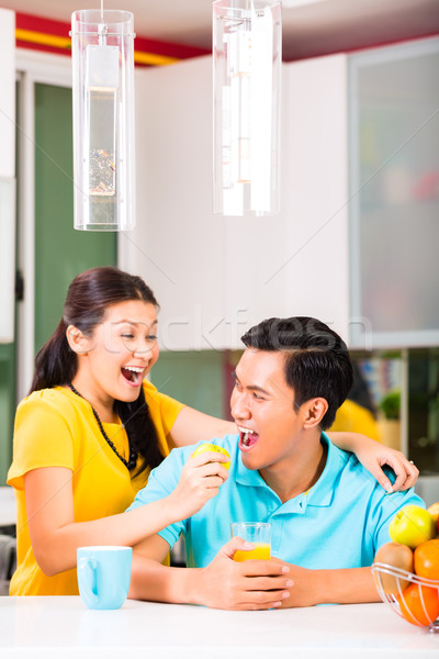 Stock photo: Asian woman feeding boyfriend with apple 