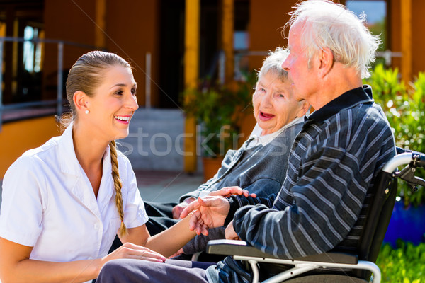 Seniors eating candy in garden of nursing home Stock photo © Kzenon