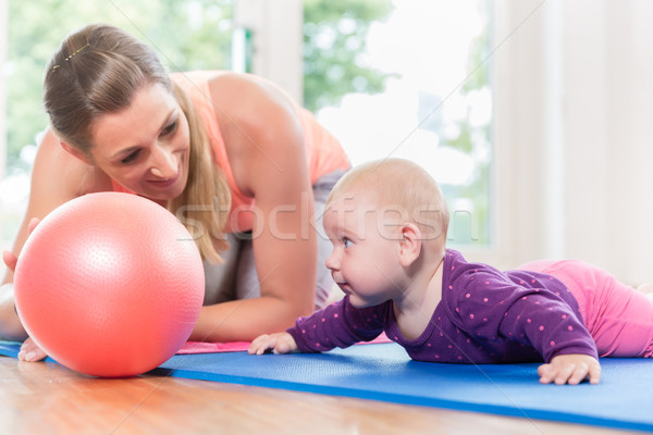 Stock photo: Mom and her baby practicing to crawl in mother and child course
