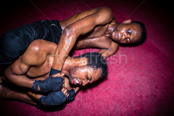 Stock photo: Two African American opponents struggling for dominance in groun