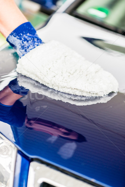 Man polishing his car using a mitt Stock photo © Kzenon