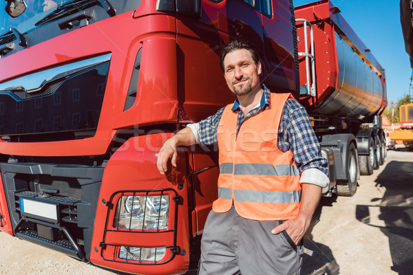 Truck driver in front of his freight forward lorry Stock photo © Kzenon