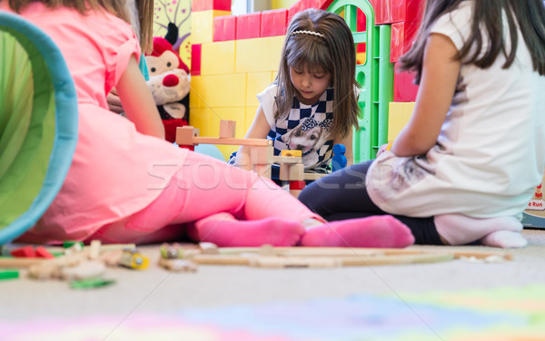 Cute girl building a structure from toy blocks during playtime Stock photo © Kzenon