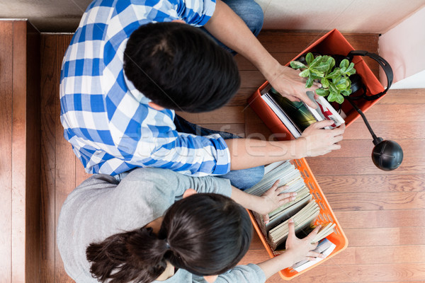 Young asian couple carrying belongings to new apartment Stock photo © Kzenon