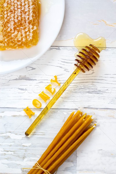 tasty organic honey in a honeycomb and honey lip balm on a wooden, vintage background Stock photo © laciatek