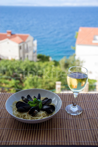 Tasty moule and a glass of white wine Stock photo © laciatek