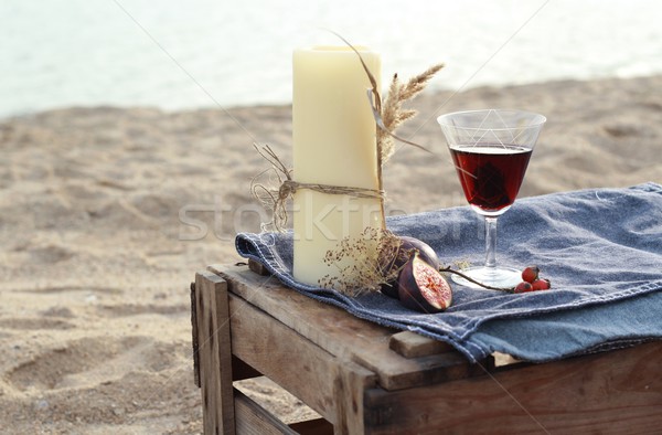 candles and red wine - romantic dinner on the water in Scandinavian style  Stock photo © laciatek